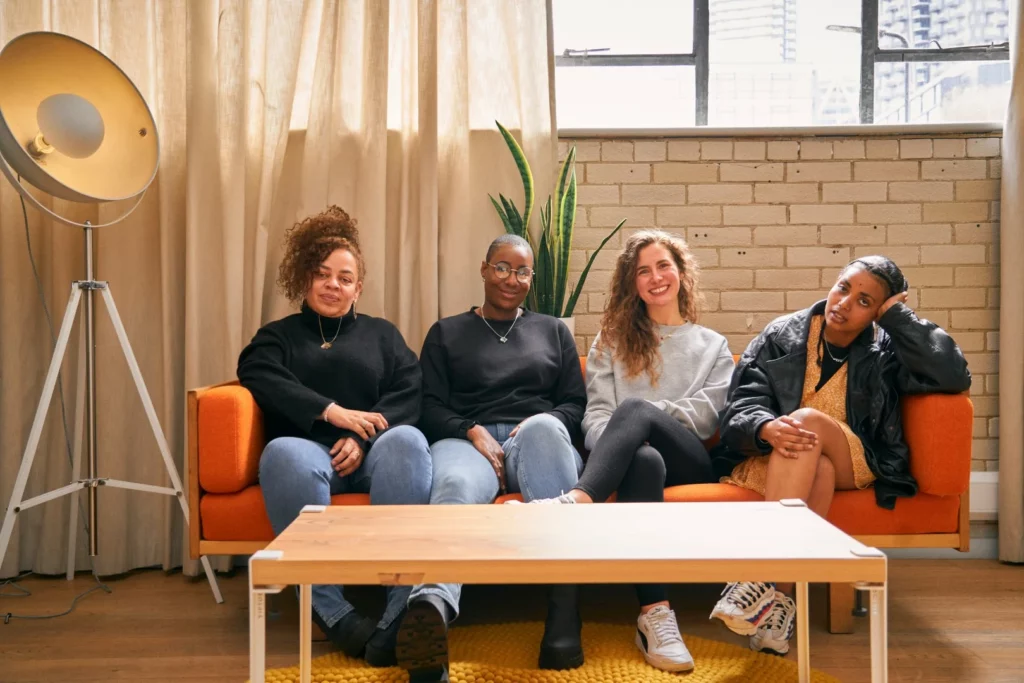 friends sitting on a couch laughing